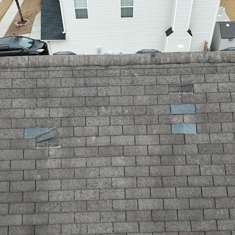 Roof shingles with replaced damaged sections in Loganville, GA