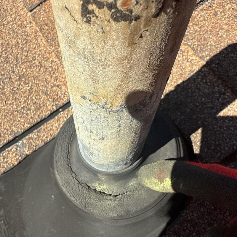 Roof pipe flashing with visible cracks and wear
