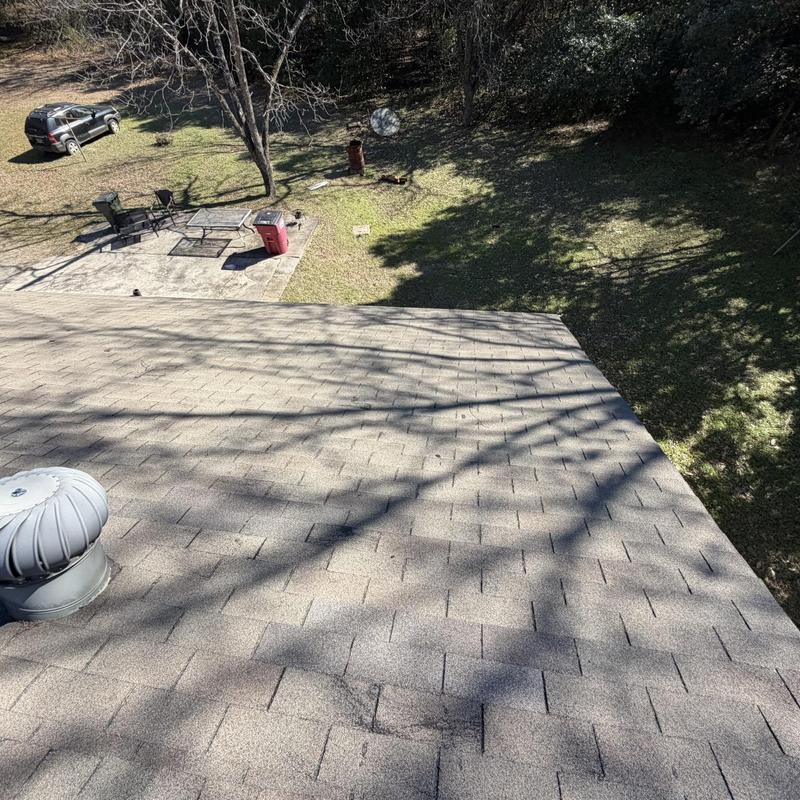 Asphalt shingle roof with turbine vent and lawn view