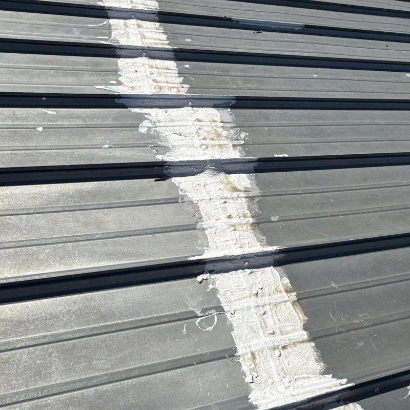 Metal roof panel with sealed joint repair and hail damage