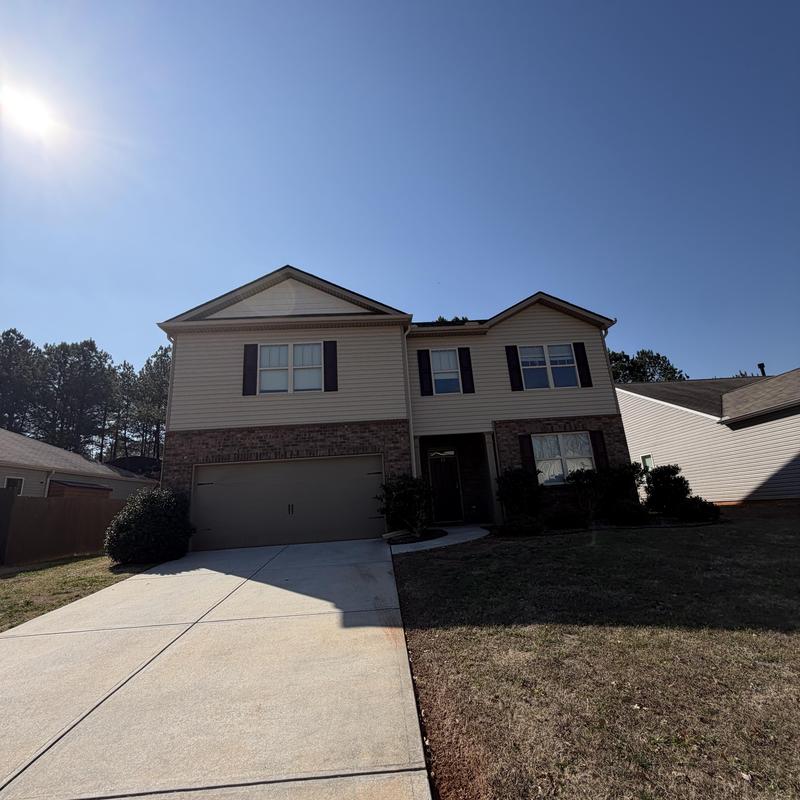 Ridge vent and shingles with tarp on two-story roof