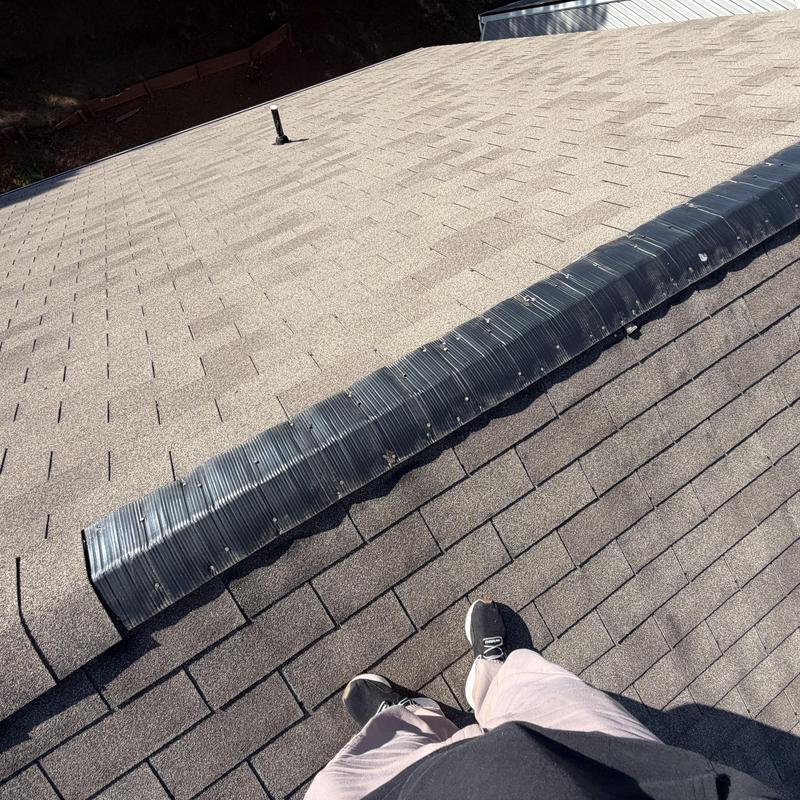 Ridge vent with damaged shingles and tarp installed