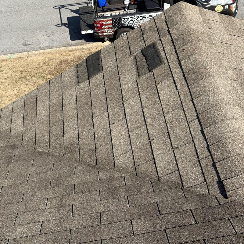 Metal ridge vent with missing and damaged shingles