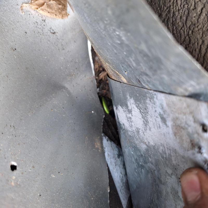 Roof flashing close-up showing worn metal edges
