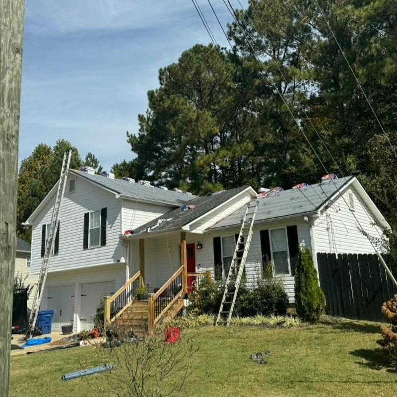 Asphalt shingle roof replacement with ladders on house