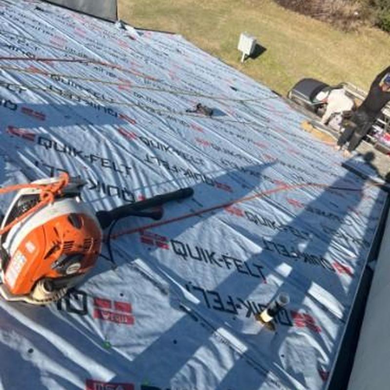 Roof underlayment installation on townhouse roof replacement