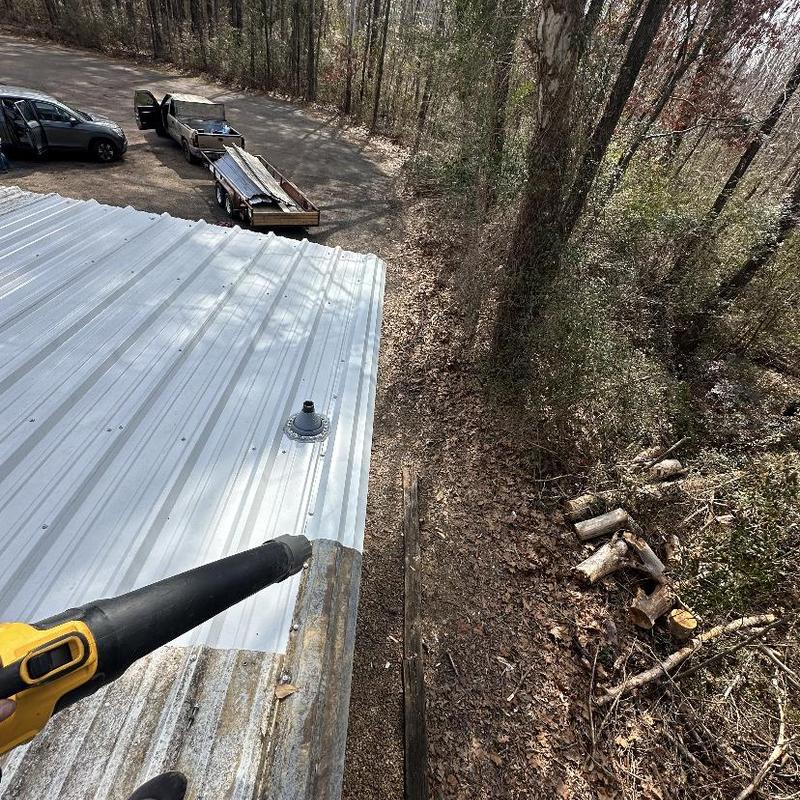 Metal roof panels installation and cleanup in progress Metal roof panels installation and cleanup in progress