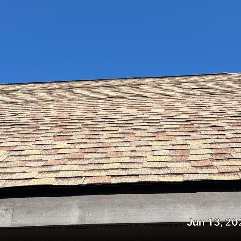 Asphalt shingle roof with wear and damage signs