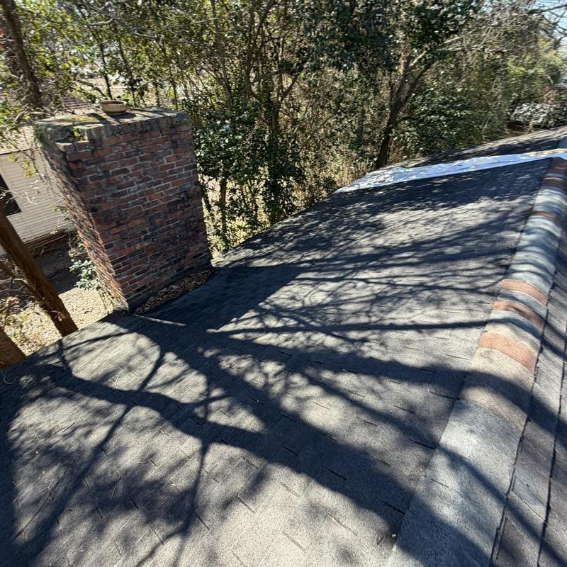 Asphalt shingle roof with chimney and roof ridge tiles