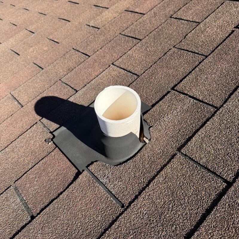 Roof pipe flashing on asphalt shingle roof close-up