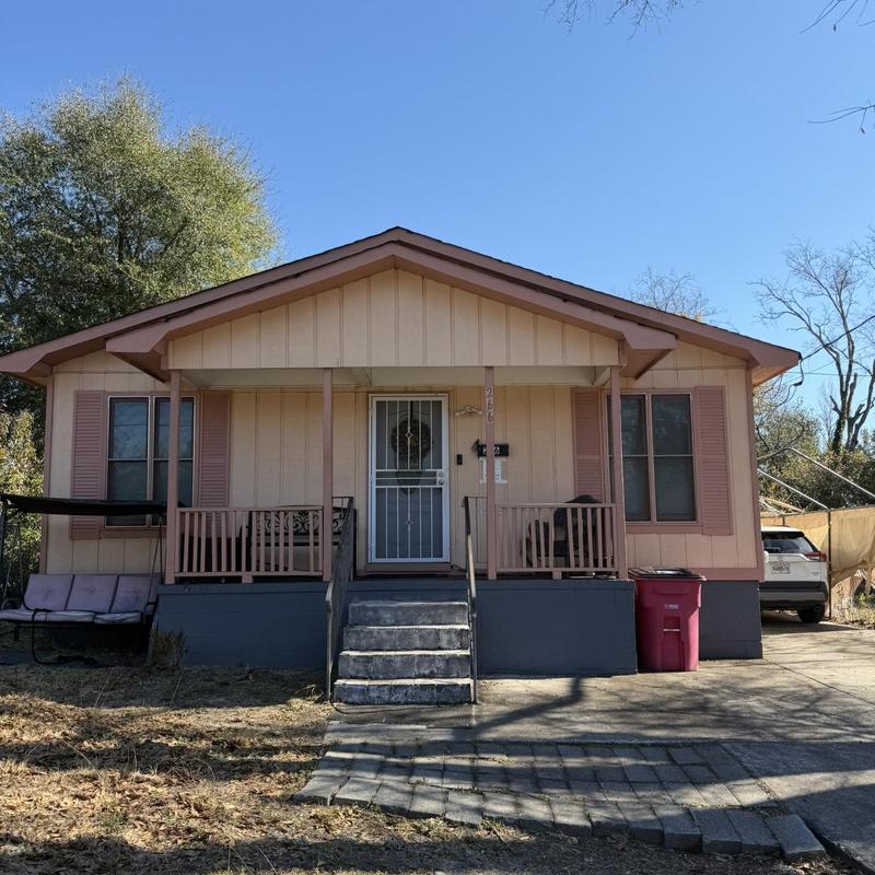 Roof of one-story house and attached porch with stairs