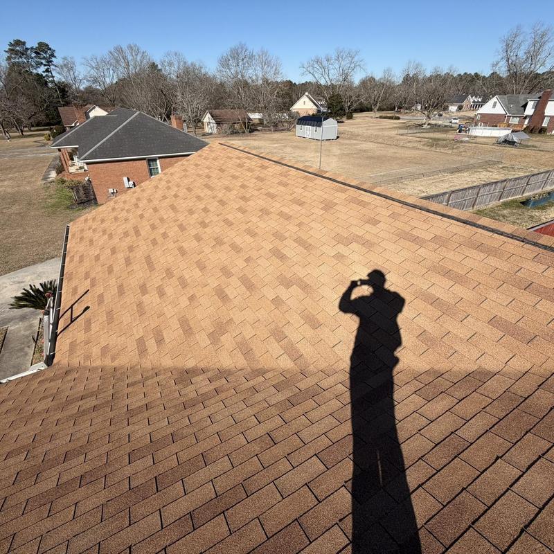 Asphalt shingle roof showing recent front patch without drip edge