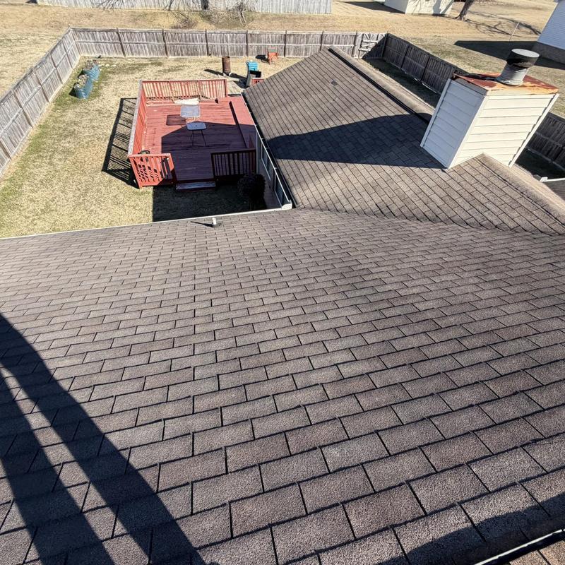 Asphalt shingle roof with chimney and fenced backyard