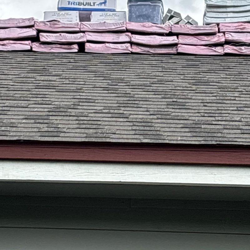 Owens Corning shingles stacked on roof edge