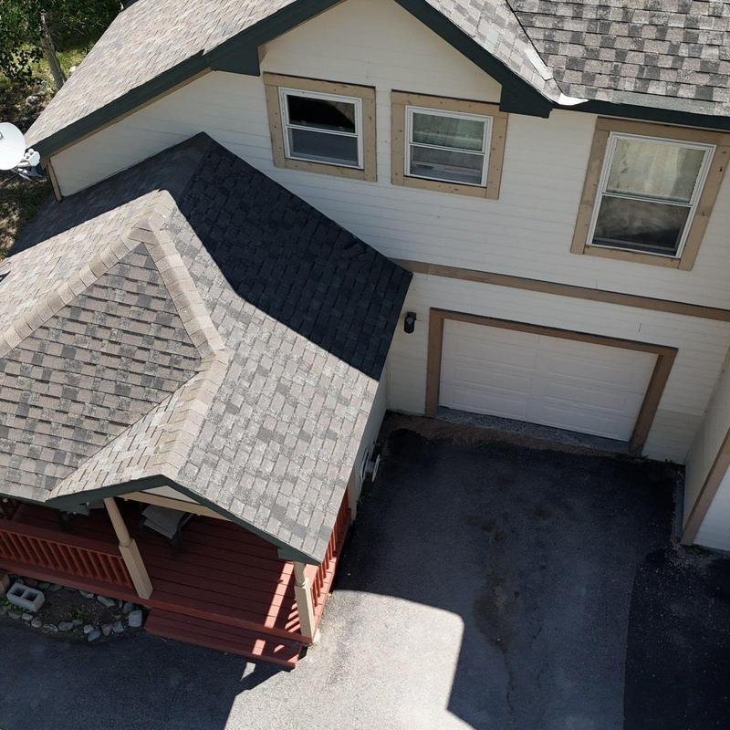 Asphalt shingle roof with porch and garage overview