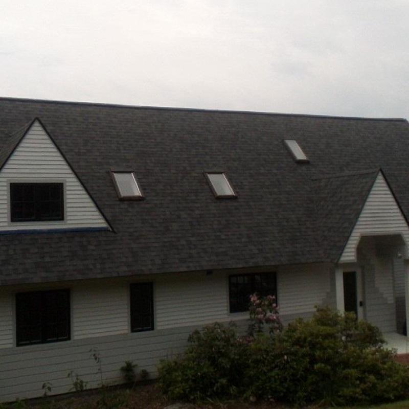 Asphalt shingle roof with skylights on residential home
