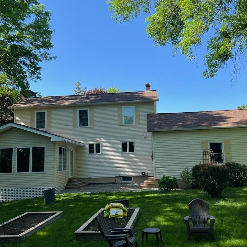 Asphalt shingle roof on two-story vinyl home