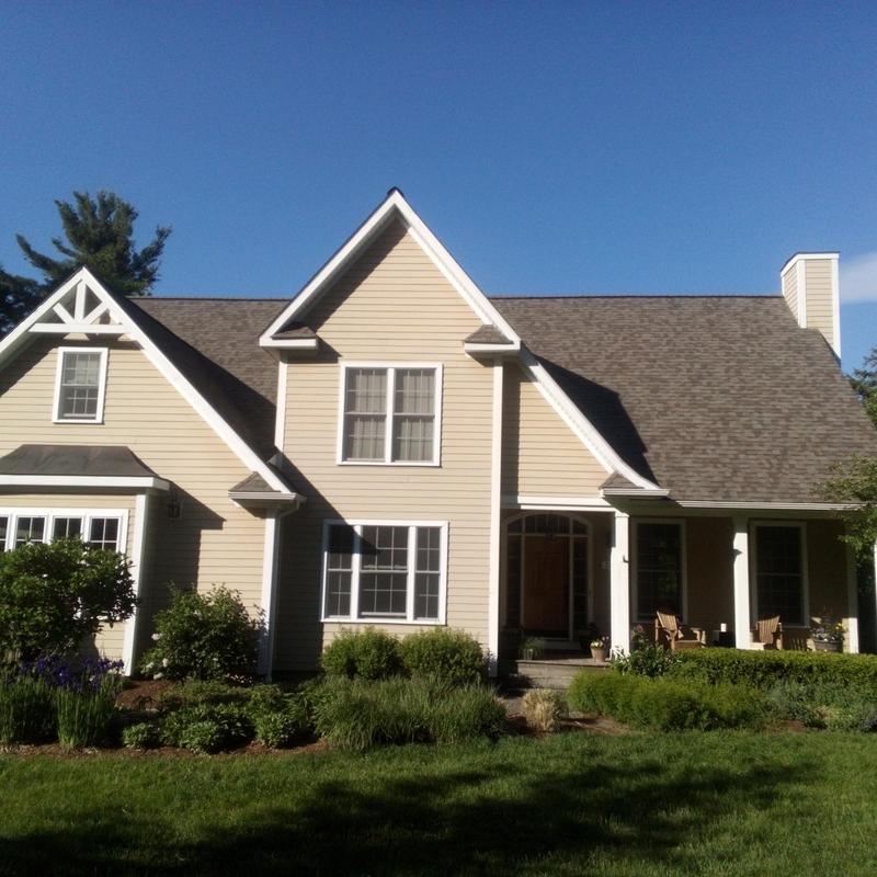 Asphalt shingle roof on beige two-story home