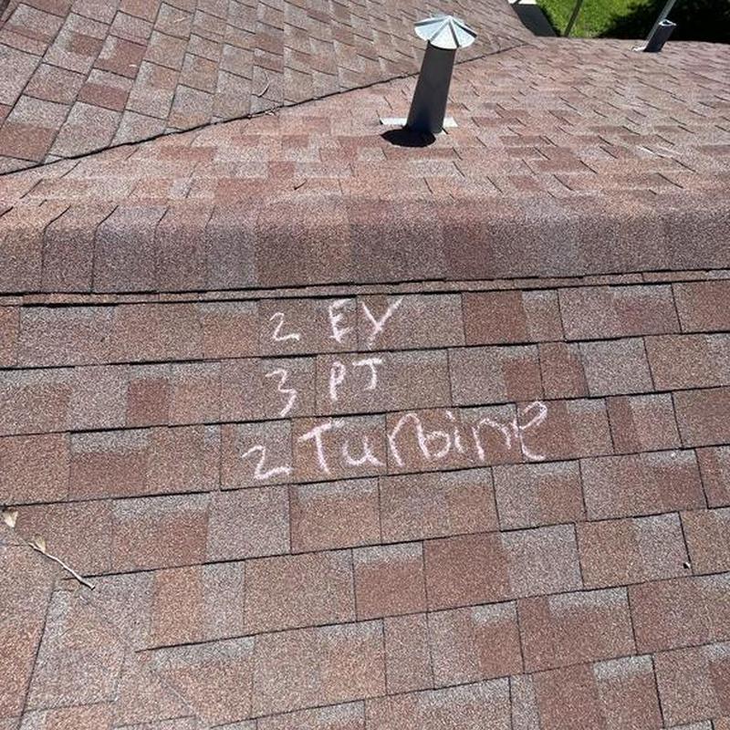 Asphalt shingle roof with hail damage markings