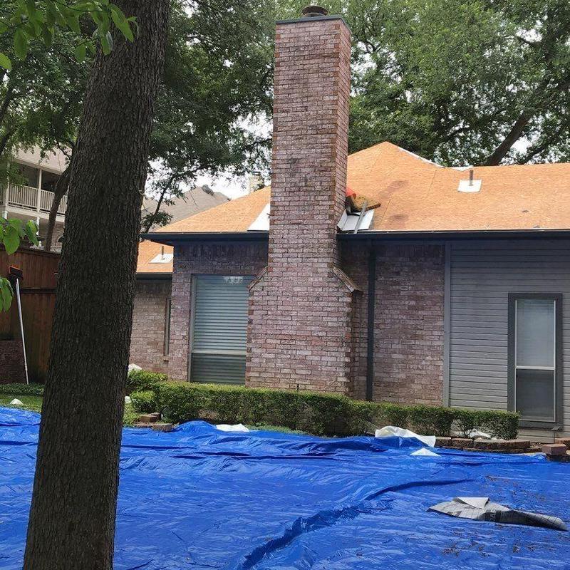 Roof decking replacement with blue tarp covering ground