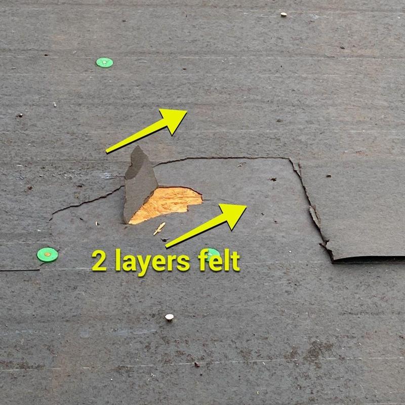Roofing felt layers peeled back revealing roof decking damage