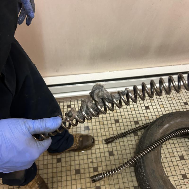 Main sewer line snake with hair and debris blockage