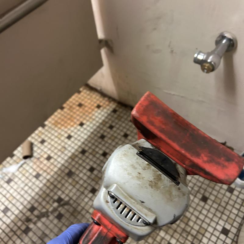 Main sewer line snaking tool in bathroom floor repair