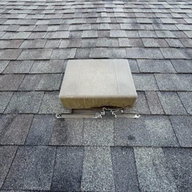 Damaged rooftop static vent on asphalt shingle roof