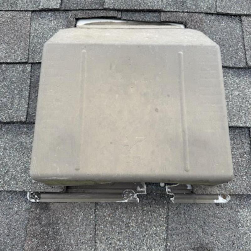 Roof vent on asphalt shingle roof with damaged base