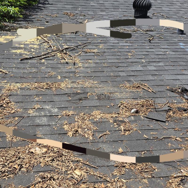 Asphalt shingle roof with storm damage and debris