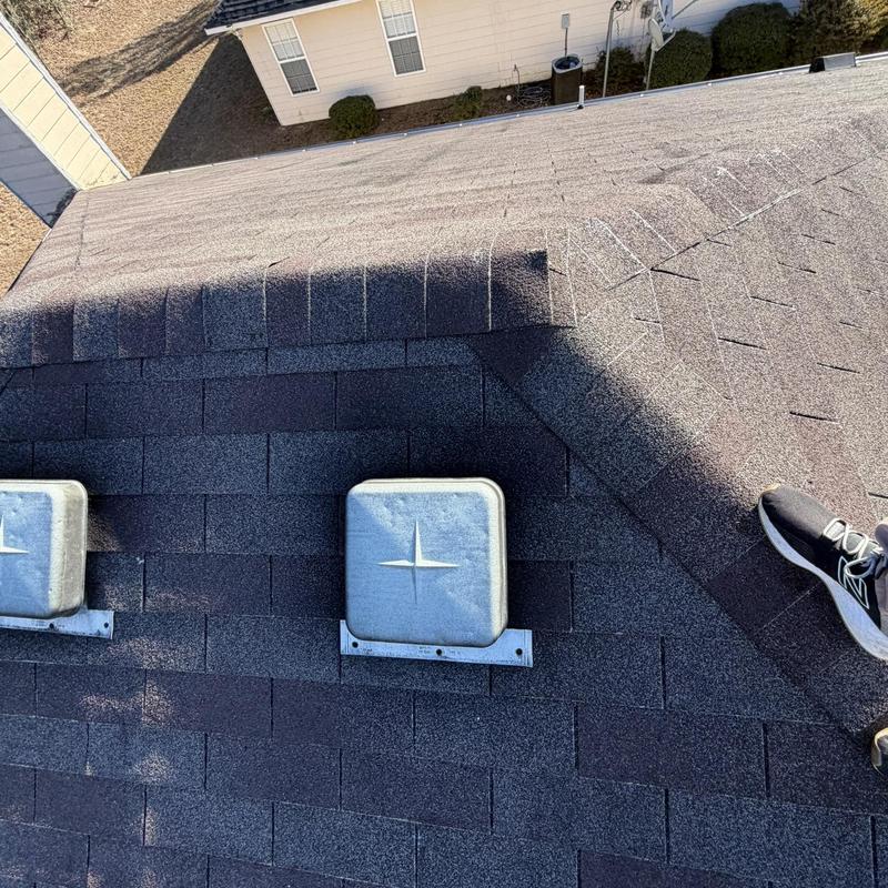 Roof shingles and vent covers on residential roof