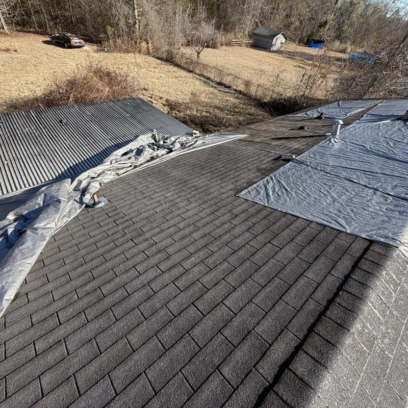 Roof shingles and tarp covering on residential roof