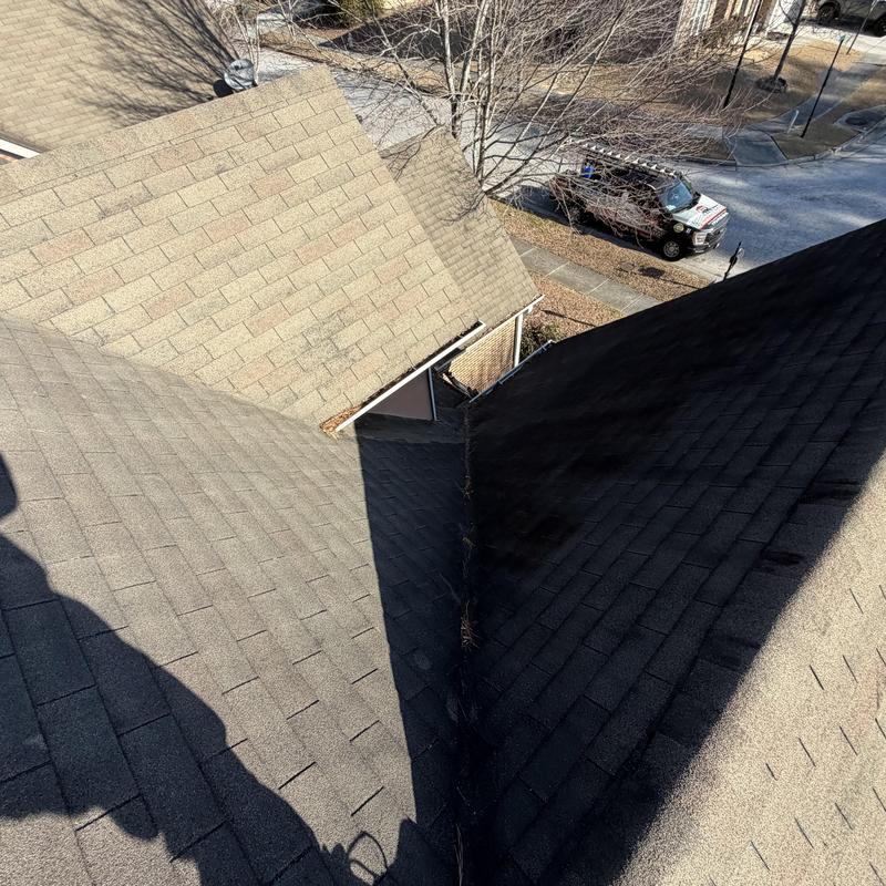 3-tab roof valley with sealed nails and debris buildup