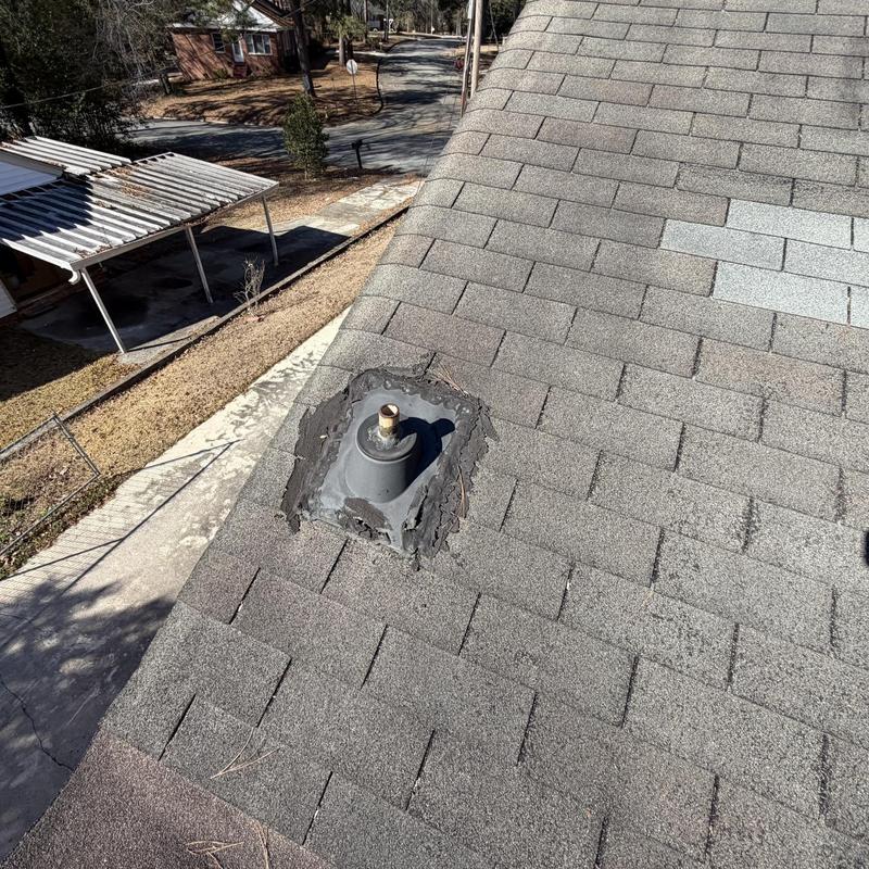 Roof vent flashing with worn sealant on shingle roof