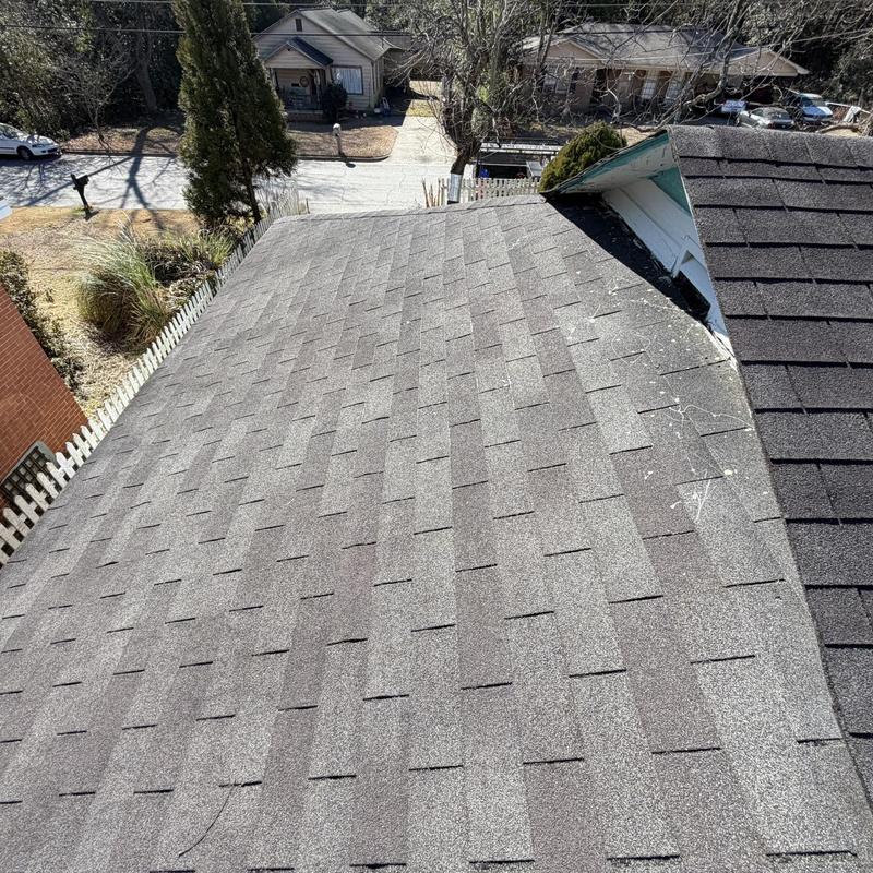 Asphalt shingle roof with visible wear and deck repairs needed