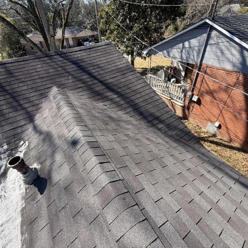 Roof shingles with ridge and vent pipe visible