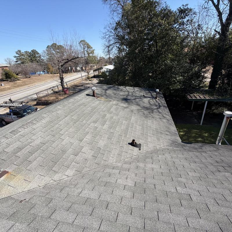 Asphalt shingle roof with vent pipes and chimney caps