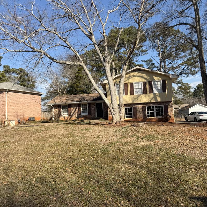 Gutter system clogged needing cleaning, two-story house