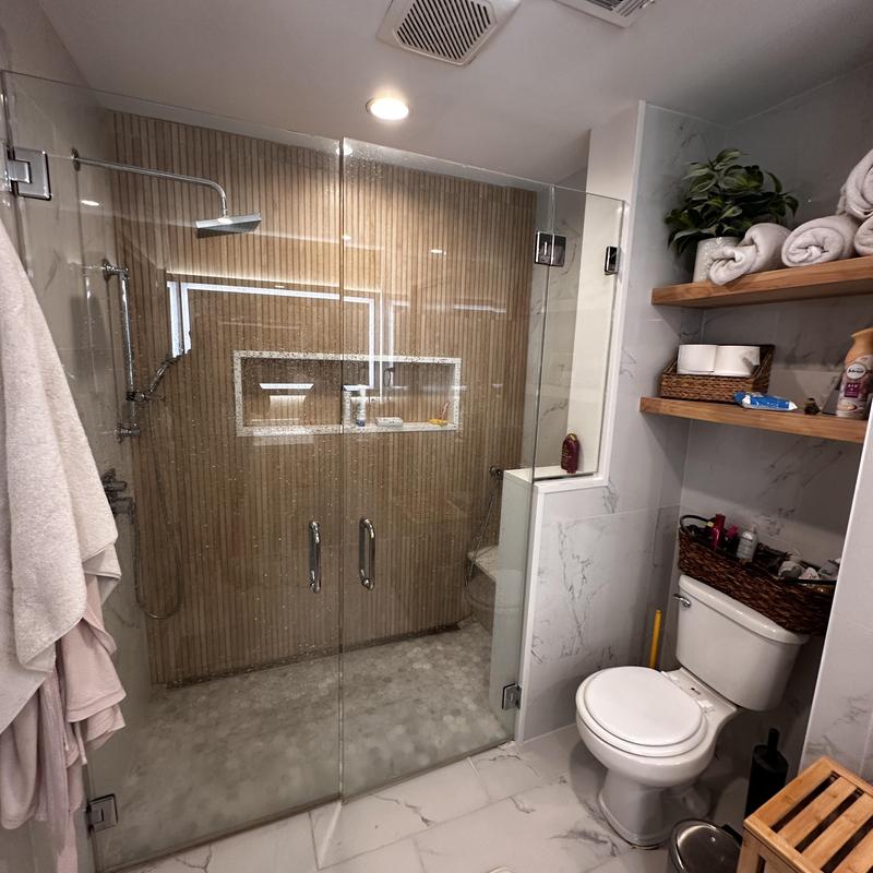 Glass shower enclosure with rain shower head Glass shower enclosure with rain shower head