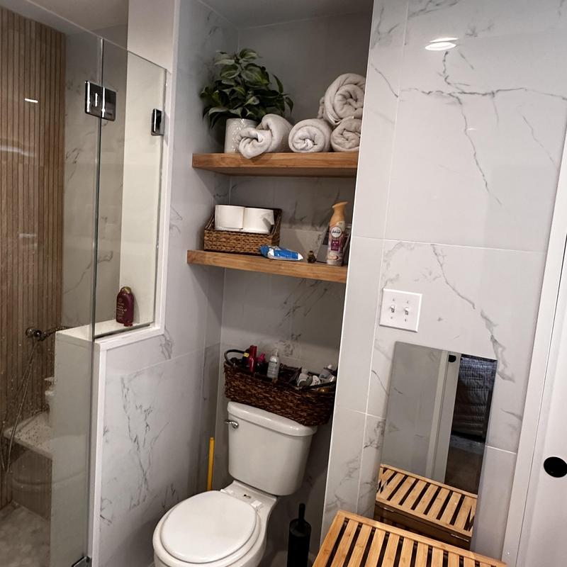 Groutless shower unit inspection with bathroom storage shelves Groutless shower unit inspection with bathroom storage shelves