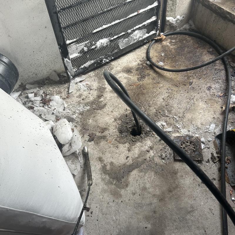 Frozen pipe with hydro jet hose clearing ice blockage