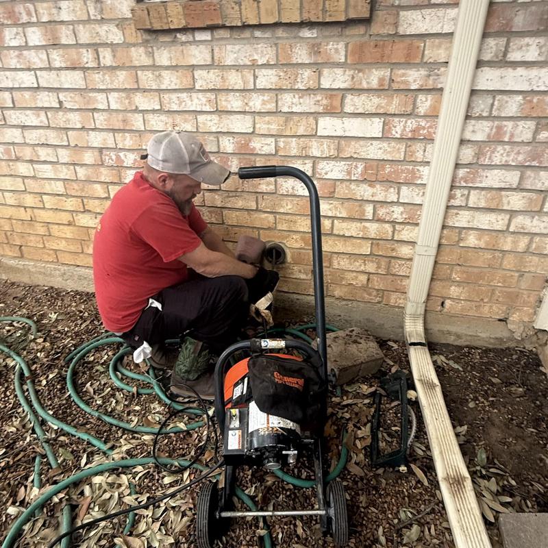 Kitchen drain cleaning with motorized auger and plumber