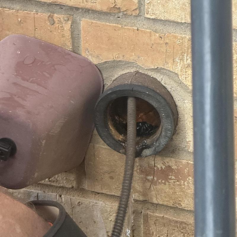 Kitchen drain cleaning snake inside wall pipe
