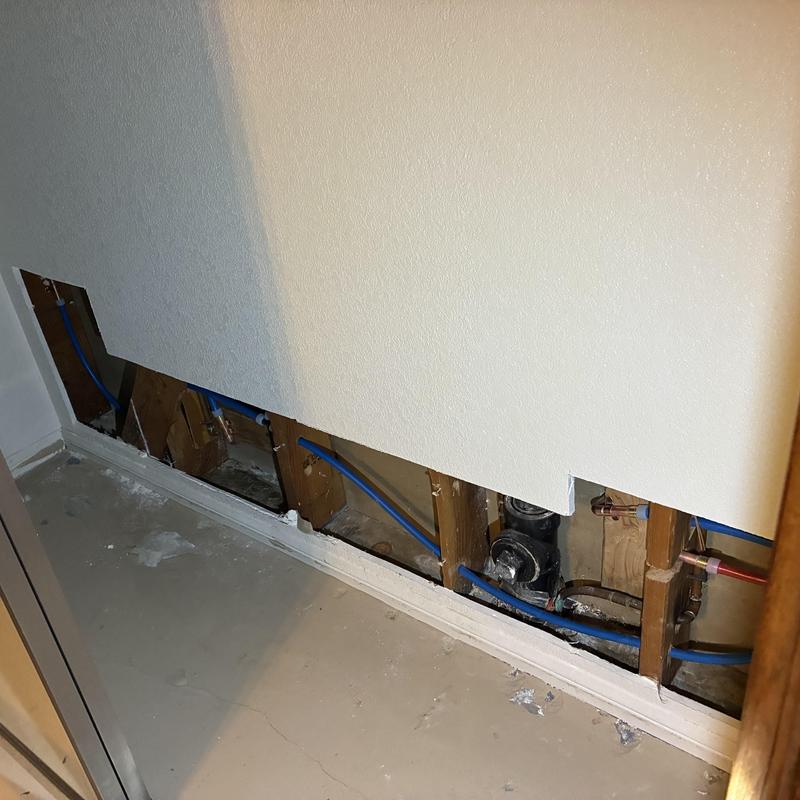 Cold water plumbing lines behind removed drywall panel Cold water plumbing lines behind removed drywall panel