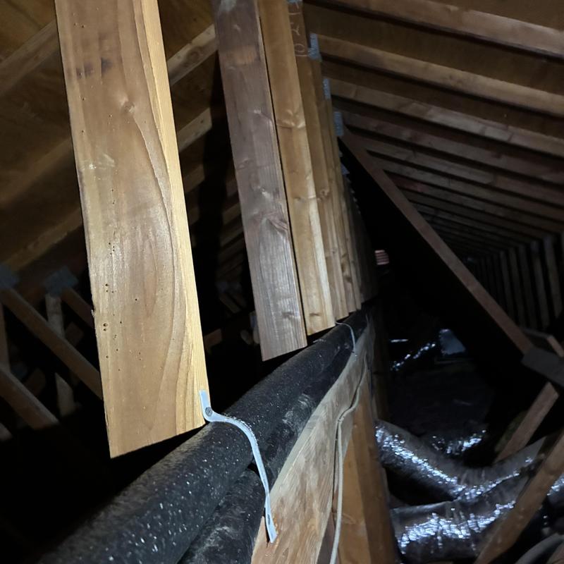 Hot water pipe reroute in attic with wood framing Hot water pipe reroute in attic with wood framing