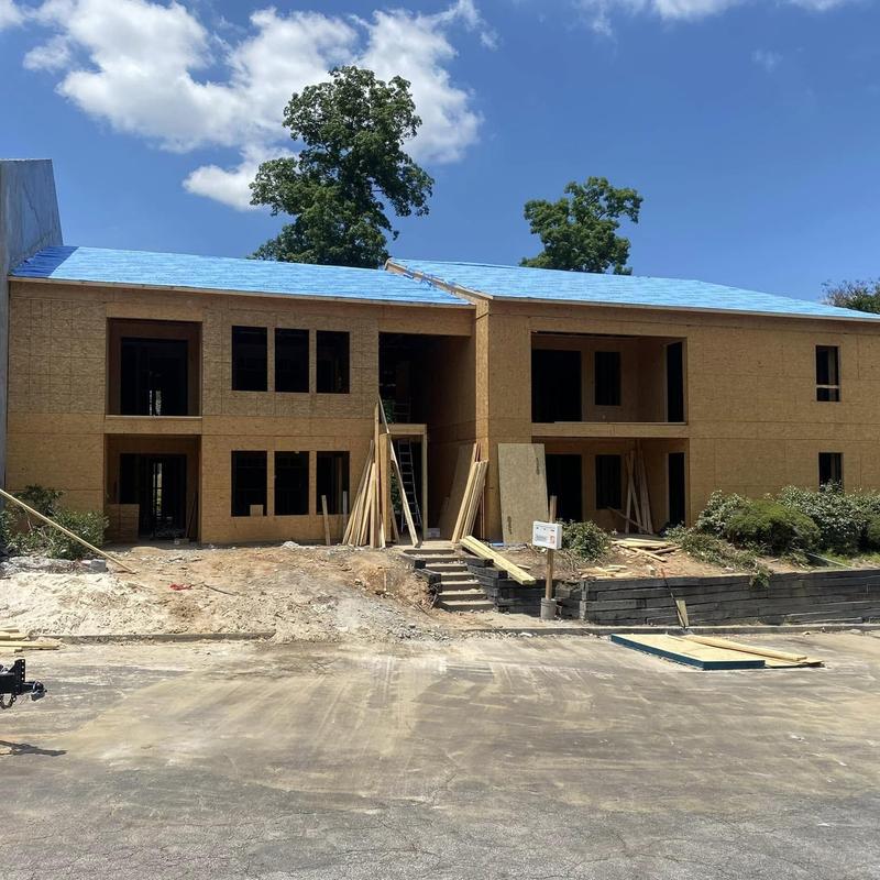 Apartment building roof with blue underlayment installed