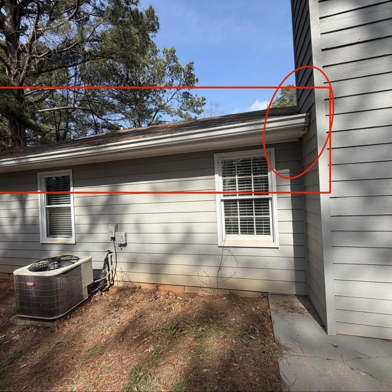 Wood fascia and soffit damage near chimney flashing