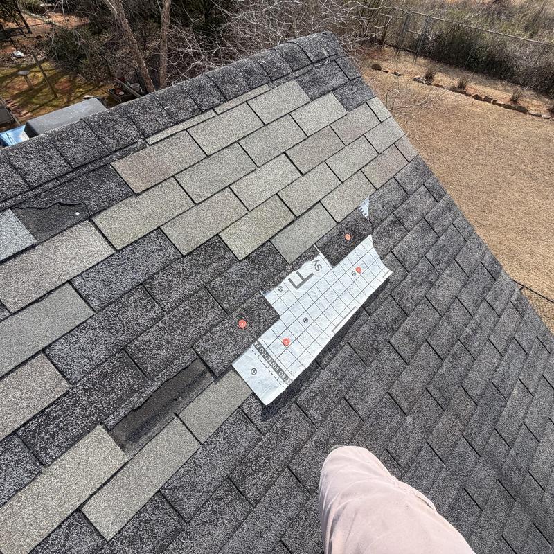 Asphalt shingles missing with exposed underlayment on roof
