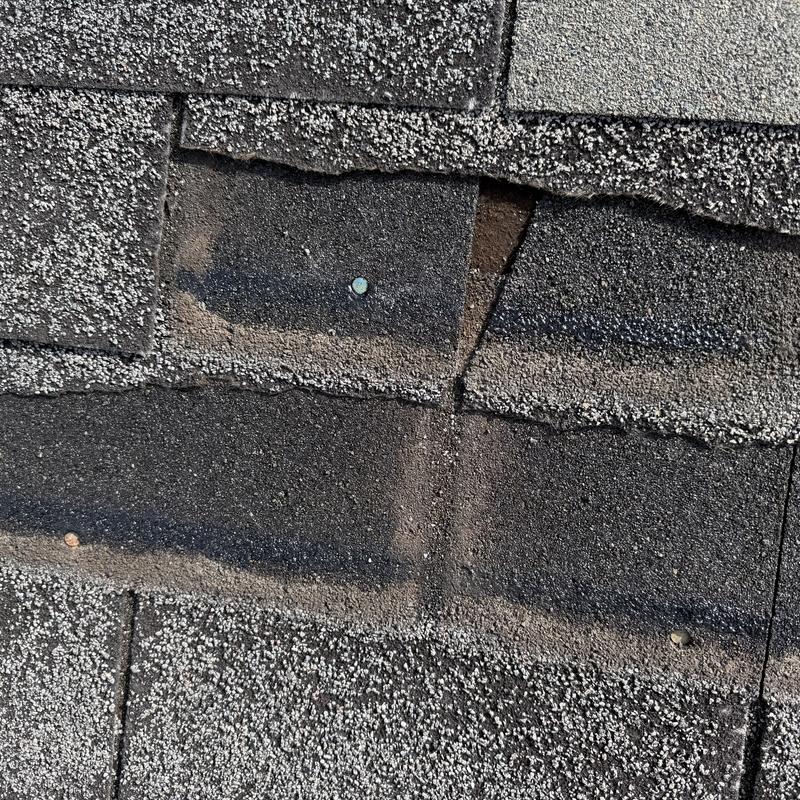 Roof shingles with missing and damaged sections