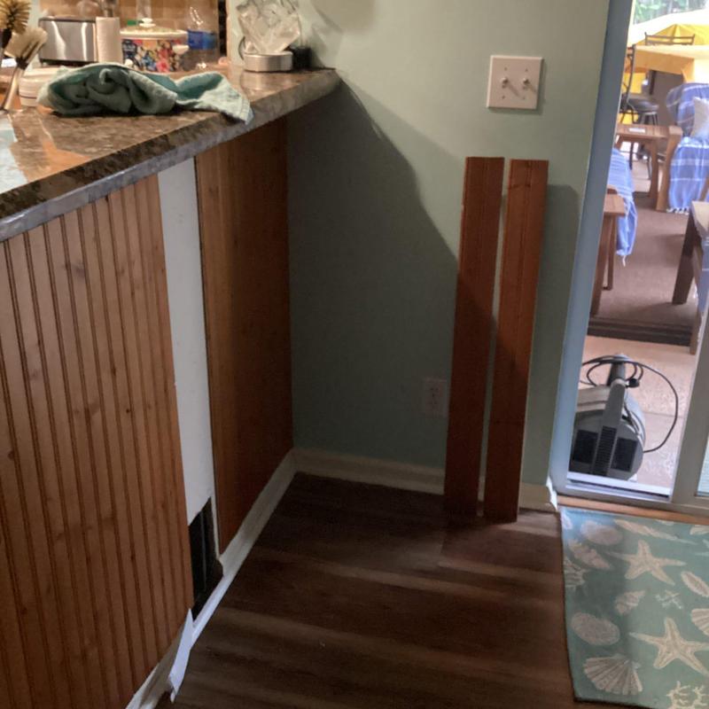 Kitchen base cabinet with missing panel and countertop edge